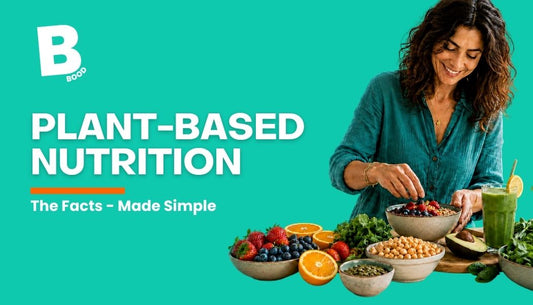 Woman preparing a colourful plant-based breakfast with fruit, vegetables and a green smoothie