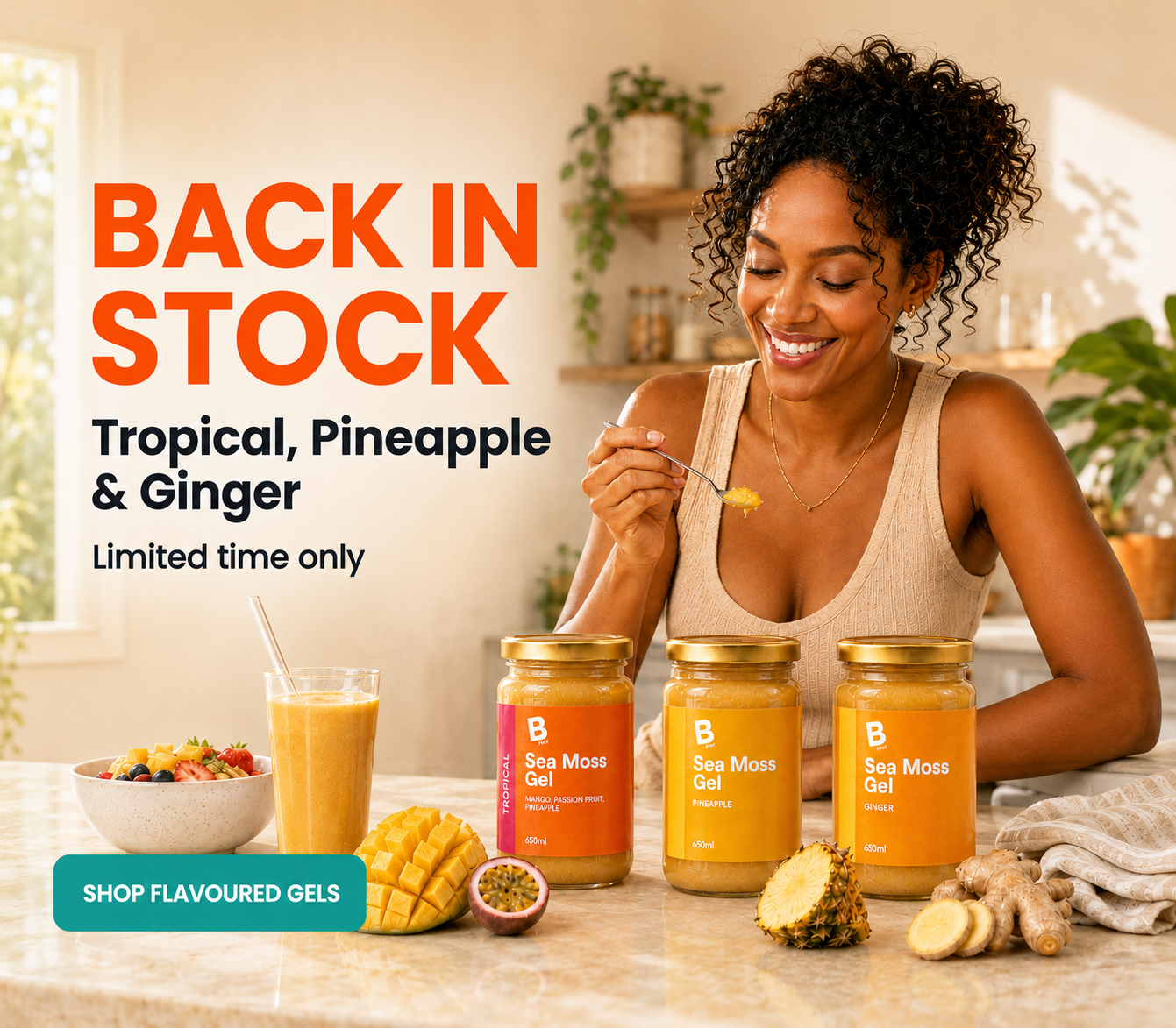 A woman sits at a kitchen counter smiling while holding a spoonful of gel, with three jars of sea moss gel and a glass of orange drink in front of her. Large text on the left reads 'BACK IN STOCK Tropical, Pineapple & Ginger Limited time only SHOP FLAVOURGED GELS'.
