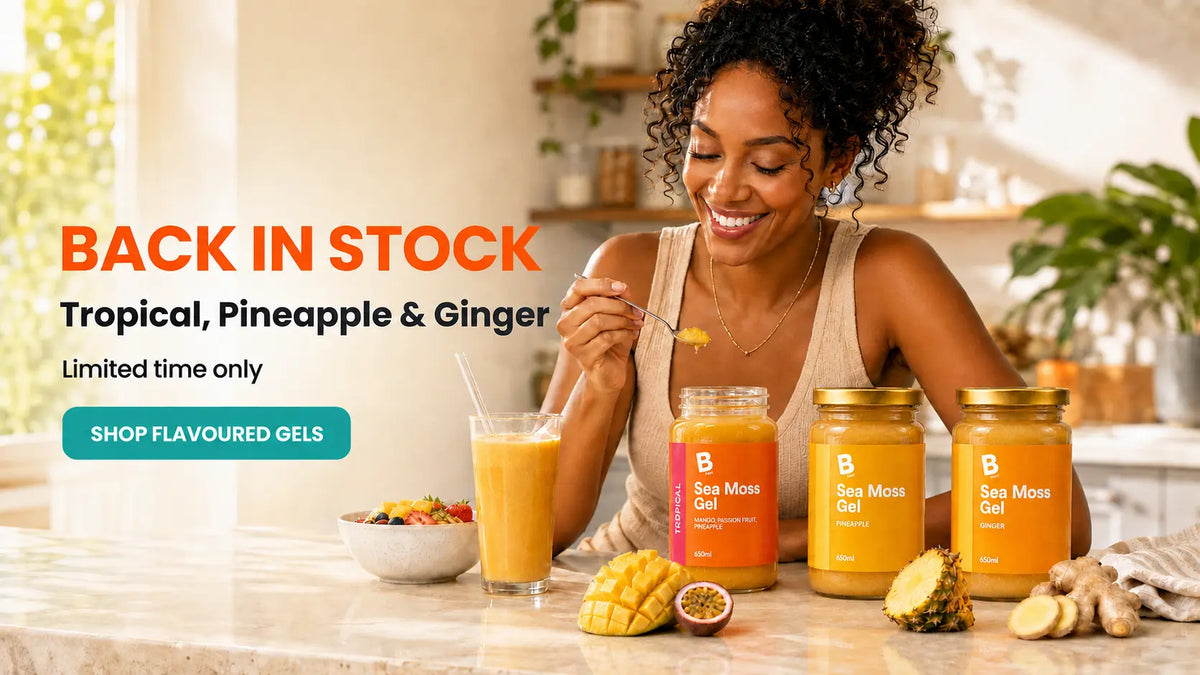 Woman with BOOD tropical, pineapple and ginger flavoured sea moss gels in a kitchen
