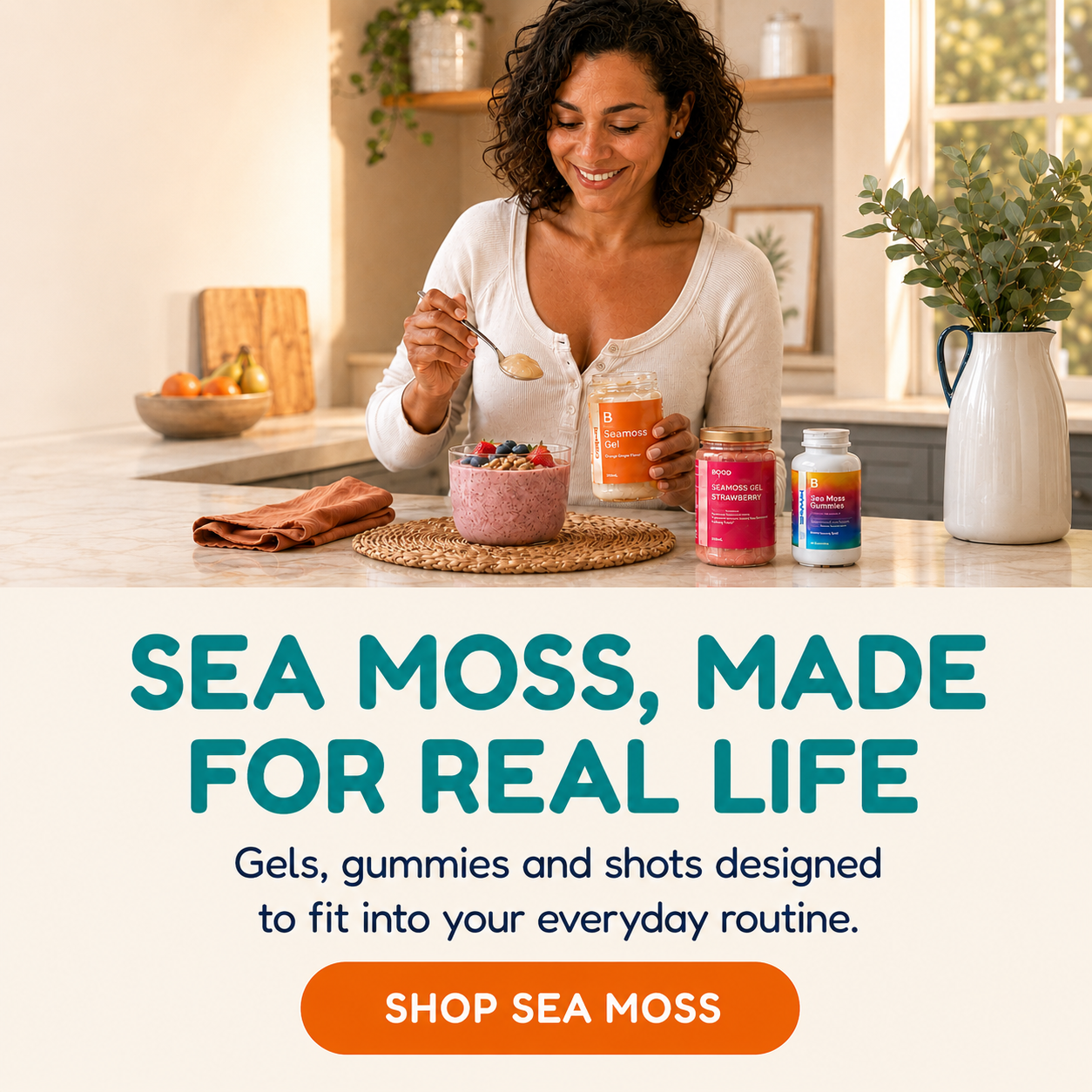 A woman in a bright kitchen holds a spoon over a bowl of pink powder while standing next to three colorful supplement jars. Large text below reads 'SEA MOSS, MADE FOR REAL LIFE' with a 'SHOP SEA MOSS' button.